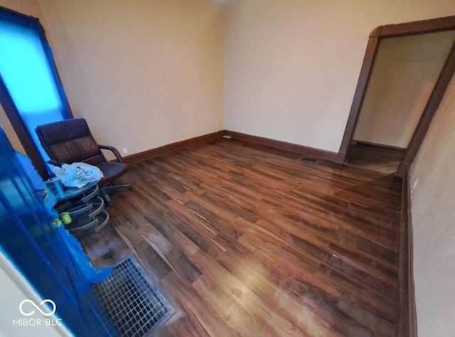 103 N Chester Ave, Indianapolis, IN 46201 - unfurnished bedroom featuring dark wood-style flooring and baseboards