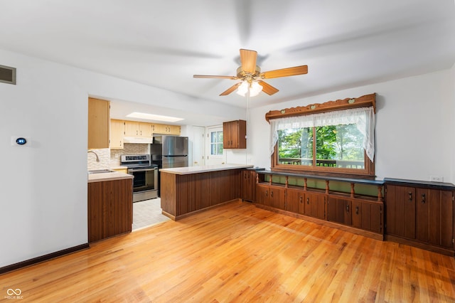 3669 Glenwood Dr, Martinsville, IN 46151 - kitchen with appliances with stainless steel finishes, light wood-type flooring, a peninsula, and plenty of natural light