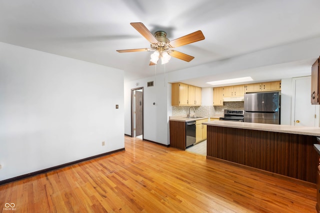 3669 Glenwood Dr, Martinsville, IN 46151 - kitchen with stainless steel appliances, light countertops, under cabinet range hood, light wood-style floors, and decorative backsplash