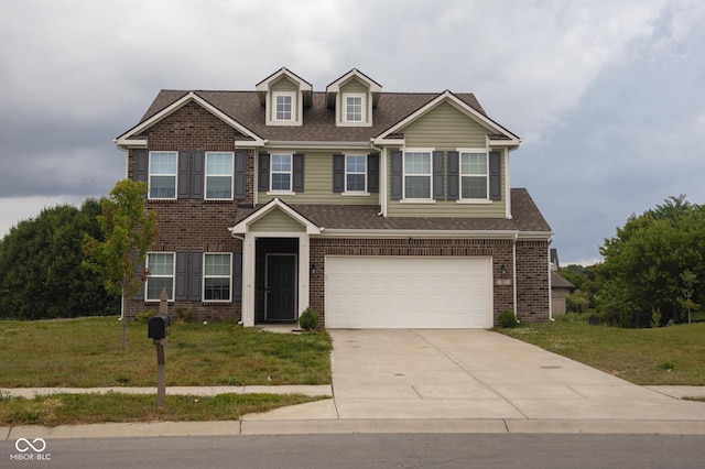 907 Ram Dr, Franklin, IN 46131 - view of front facade with driveway, a garage, a front yard, and brick siding