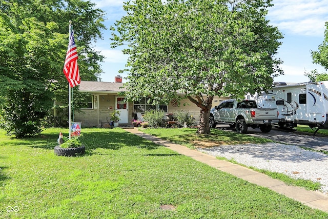 3534 Carr Ave, Indianapolis, IN 46221 - view of front of house featuring a front yard, a chimney, and driveway