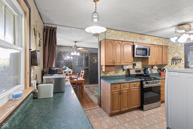 3534 Carr Ave, Indianapolis, IN 46221 - kitchen featuring appliances with stainless steel finishes, a textured ceiling, a ceiling fan, dark countertops, and light floors