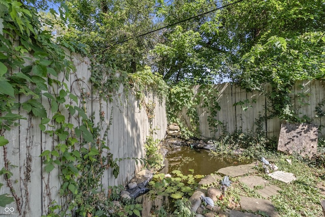 3534 Carr Ave, Indianapolis, IN 46221 - fenced backyard with a garden pond