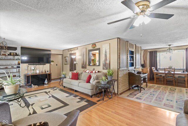 3534 Carr Ave, Indianapolis, IN 46221 - living area with a textured ceiling, a ceiling fan, and wood finished floors