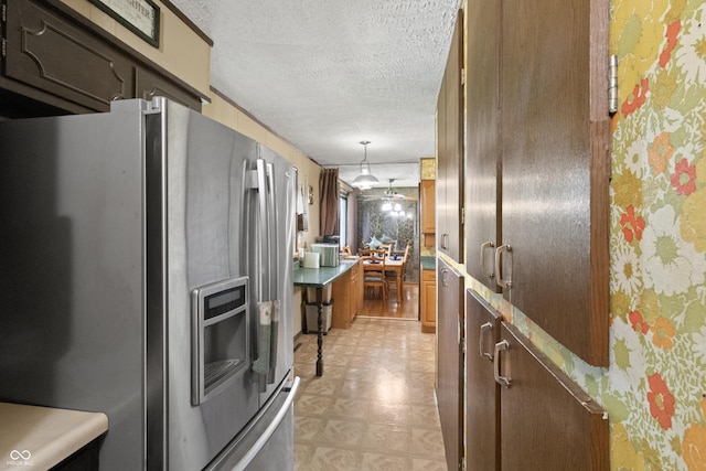 3534 Carr Ave, Indianapolis, IN 46221 - kitchen with stainless steel fridge with ice dispenser, a textured ceiling, light floors, brown cabinetry, and pendant lighting