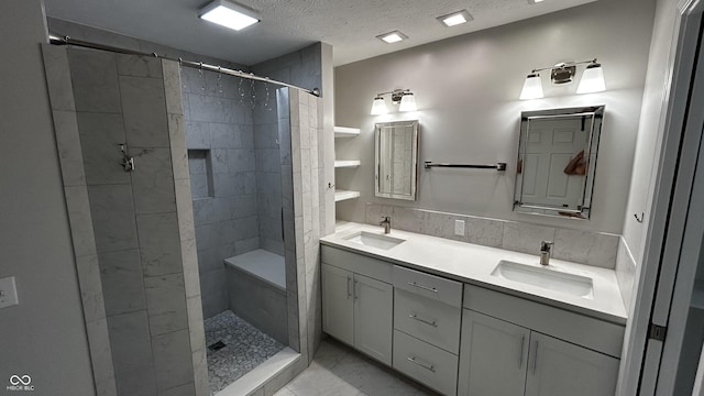 2083 Kerns Ct, Carmel, IN 46280 - full bathroom featuring double vanity, marble finish flooring, tiled shower, and a textured ceiling