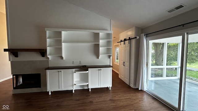 2083 Kerns Ct, Carmel, IN 46280 - kitchen featuring open shelves, dark countertops, dark wood-style floors, white cabinets, and lofted ceiling