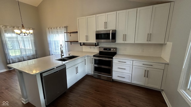 2083 Kerns Ct, Carmel, IN 46280 - kitchen featuring appliances with stainless steel finishes, open shelves, a chandelier, white cabinets, and light countertops
