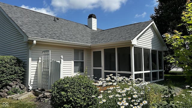2083 Kerns Ct, Carmel, IN 46280 - back of house with roof with shingles, a sunroom, and a chimney