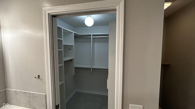 2083 Kerns Ct, Carmel, IN 46280 - walk in closet with marble look tile flooring