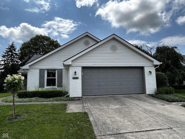 2083 Kerns Ct, Carmel, IN 46280 - ranch-style house featuring brick siding, a garage, concrete driveway, and a front yard