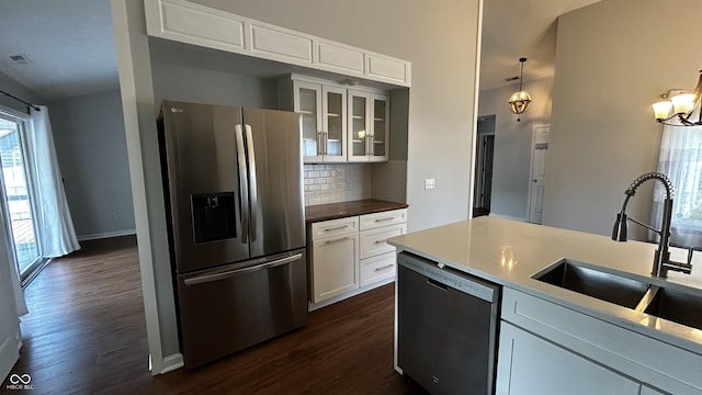 2083 Kerns Ct, Carmel, IN 46280 - kitchen featuring appliances with stainless steel finishes, dark wood-style floors, backsplash, and white cabinets