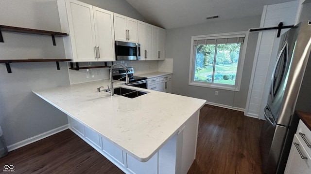 2083 Kerns Ct, Carmel, IN 46280 - kitchen with stainless steel appliances, open shelves, vaulted ceiling, backsplash, and dark wood-type flooring