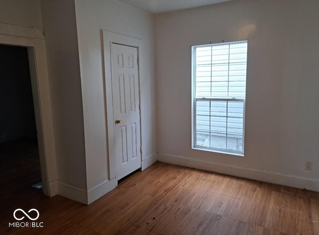 2249 E Brookside Ave, Indianapolis, IN 46218 - unfurnished bedroom featuring wood finished floors and baseboards