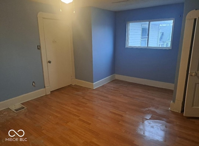 2249 E Brookside Ave, Indianapolis, IN 46218 - spare room featuring wood finished floors and baseboards
