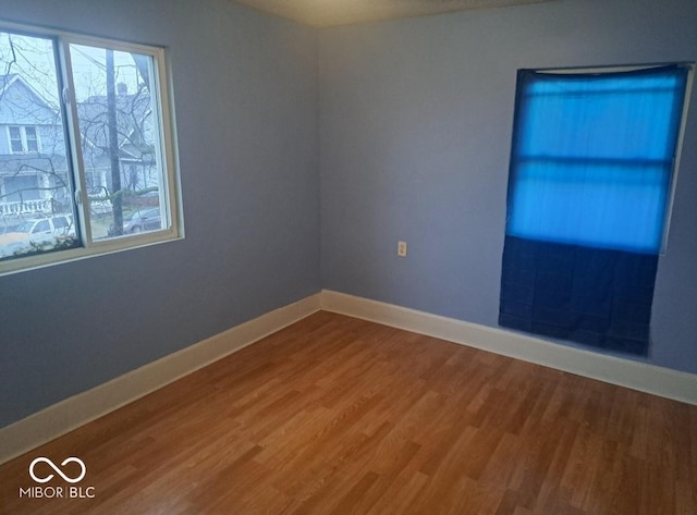 2249 E Brookside Ave, Indianapolis, IN 46218 - unfurnished room featuring wood finished floors and plenty of natural light