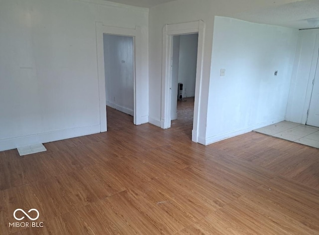 2249 E Brookside Ave, Indianapolis, IN 46218 - empty room featuring light wood-style floors and baseboards