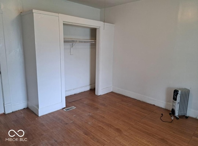 2249 E Brookside Ave, Indianapolis, IN 46218 - unfurnished bedroom featuring wood finished floors and a closet