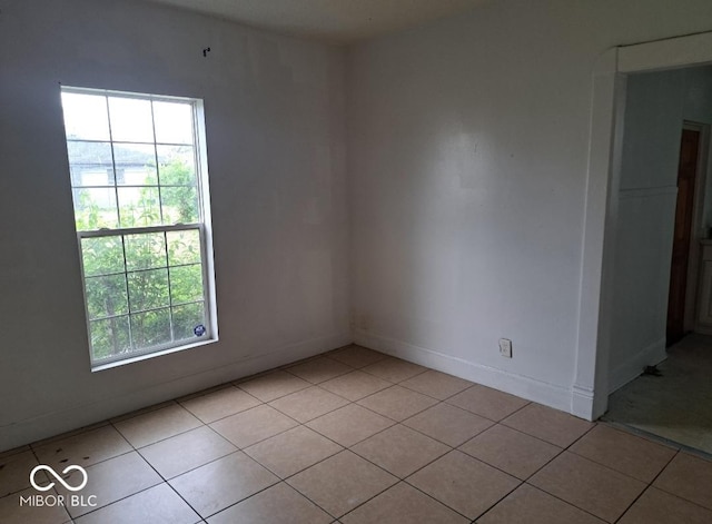 2249 E Brookside Ave, Indianapolis, IN 46218 - spare room with light tile patterned flooring and baseboards