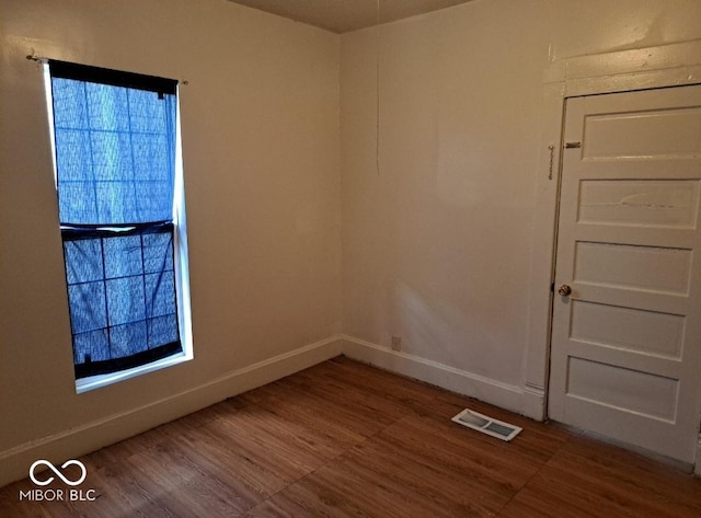 2249 E Brookside Ave, Indianapolis, IN 46218 - empty room with wood finished floors and baseboards