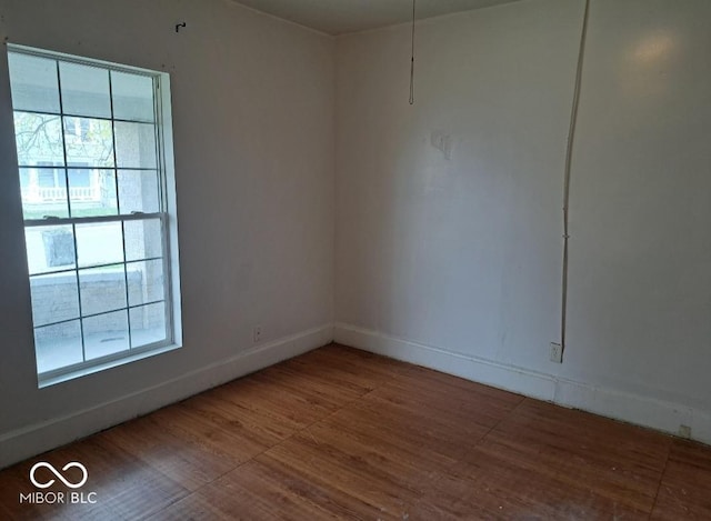 2249 E Brookside Ave, Indianapolis, IN 46218 - spare room featuring wood finished floors and baseboards