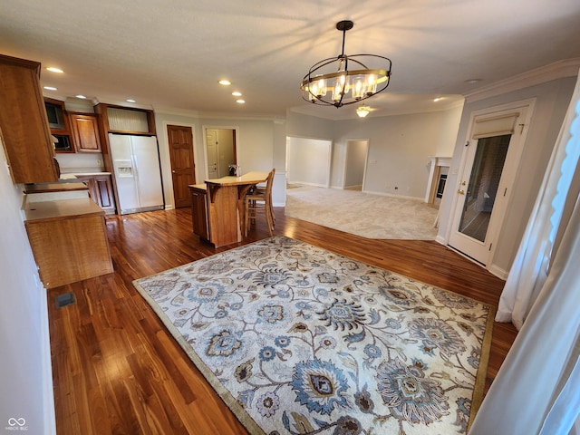 1633 Belfield St, Indianapolis, IN 46217 - kitchen featuring white refrigerator with ice dispenser, brown cabinetry, dark wood-style flooring, a chandelier, and crown molding