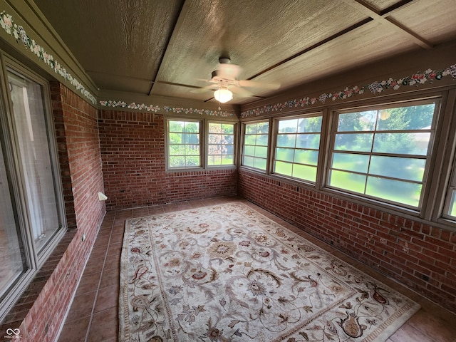 1633 Belfield St, Indianapolis, IN 46217 - unfurnished sunroom featuring brick wall and tile patterned flooring