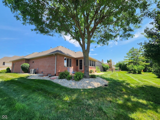 1633 Belfield St, Indianapolis, IN 46217 - back of property with brick siding and a lawn