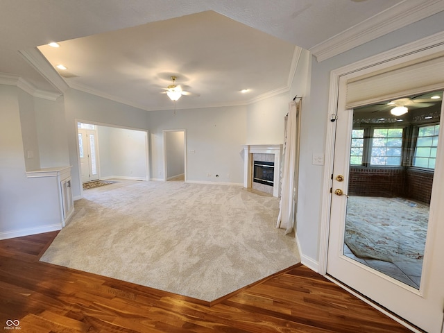1633 Belfield St, Indianapolis, IN 46217 - unfurnished living room with a ceiling fan, ornamental molding, a tile fireplace, wood finished floors, and carpet floors