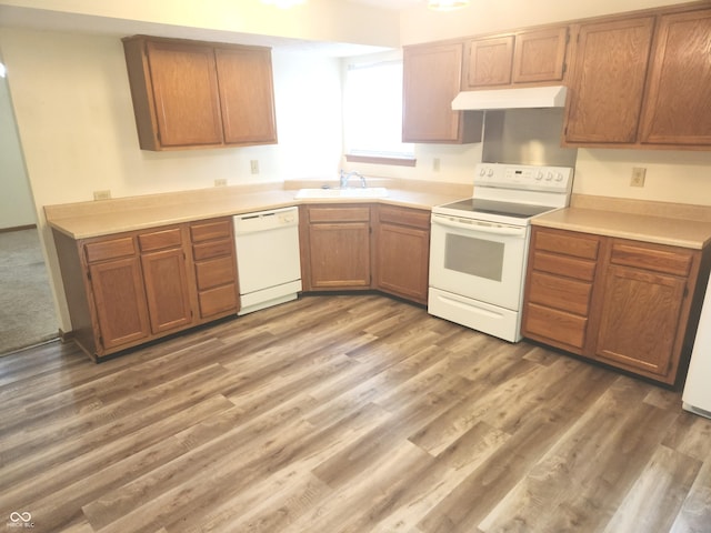 546 Grand Woods Dr, Indianapolis, IN 46224 - kitchen with white appliances, under cabinet range hood, light wood-style floors, light countertops, and brown cabinets