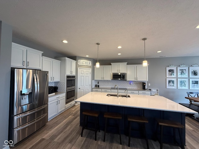 19280 Scofield Ridge Blvd, Westfield, IN 46062 - kitchen featuring appliances with stainless steel finishes, white cabinetry, dark wood-style floors, tasteful backsplash, and recessed lighting