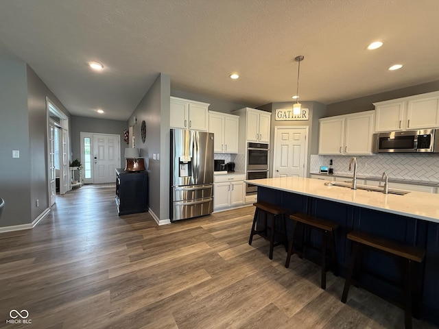 19280 Scofield Ridge Blvd, Westfield, IN 46062 - kitchen with stainless steel appliances, white cabinetry, decorative backsplash, dark wood-style floors, and recessed lighting