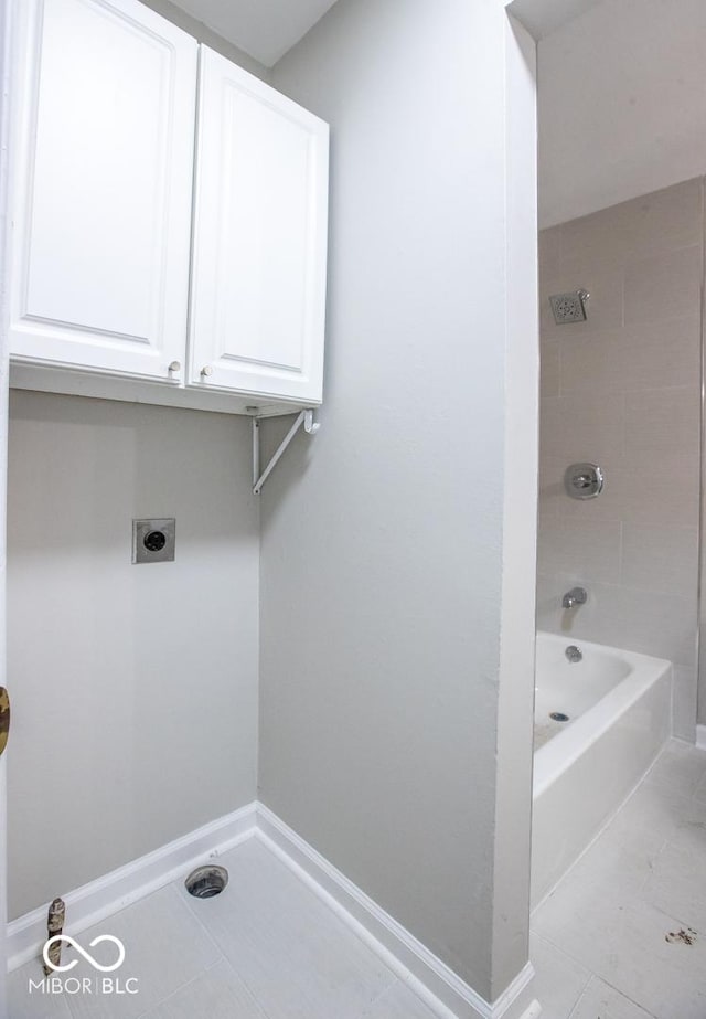 8650 Holliday Dr, Indianapolis, IN 46260 - laundry room featuring hookup for an electric dryer, cabinet space, and tile patterned flooring