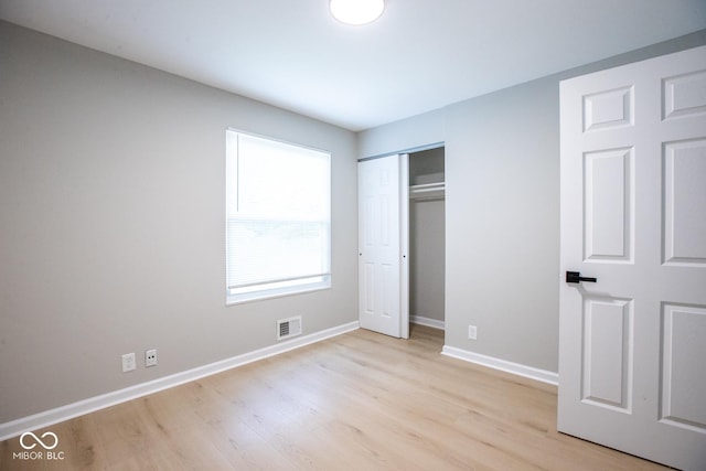 8650 Holliday Dr, Indianapolis, IN 46260 - unfurnished bedroom featuring light wood-type flooring and a closet