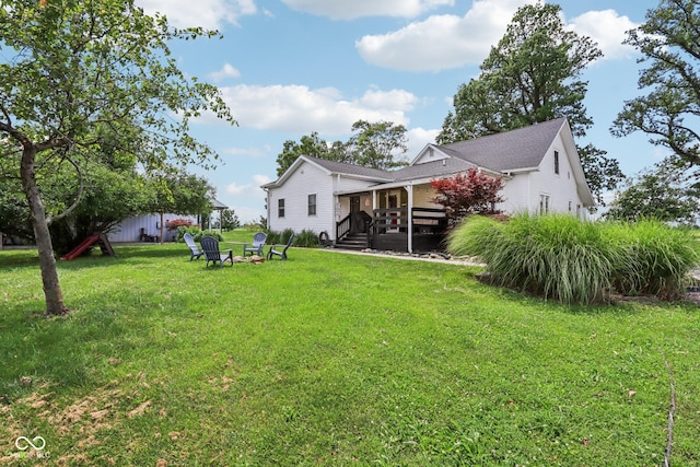 26735 Six Points Rd, Sheridan, IN 46069 - view of grassy yard with a fire pit and a wooden deck