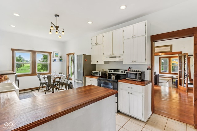 26735 Six Points Rd, Sheridan, IN 46069 - kitchen with appliances with stainless steel finishes, wooden counters, under cabinet range hood, recessed lighting, and light tile patterned floors