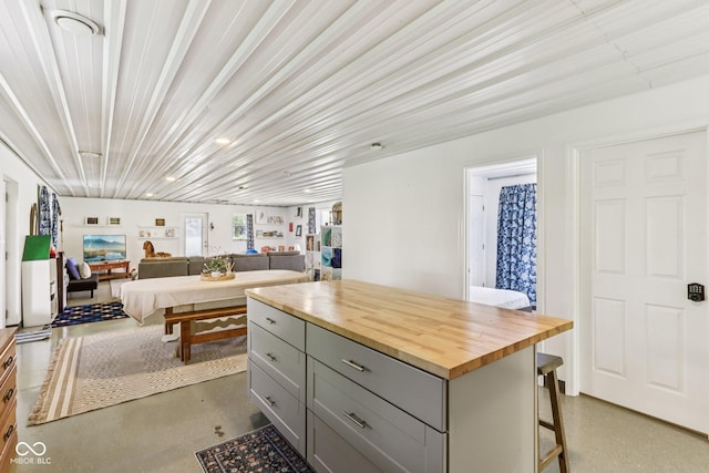 26735 Six Points Rd, Sheridan, IN 46069 - kitchen featuring gray cabinetry, butcher block counters, a kitchen breakfast bar, a kitchen island, and concrete flooring