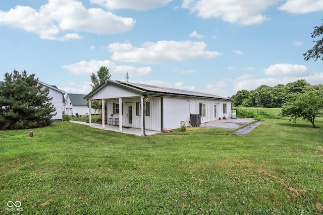 26735 Six Points Rd, Sheridan, IN 46069 - back of property featuring a patio area, a lawn, and roof mounted solar panels
