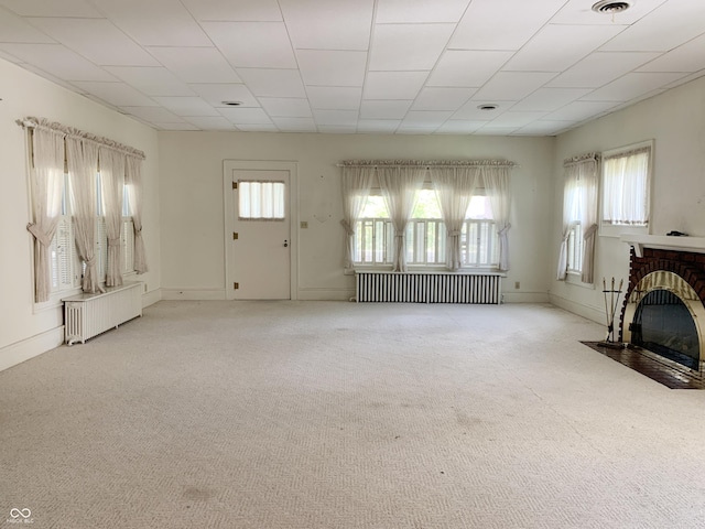 236 N Maple St, Dana, IN 47847 - unfurnished living room with radiator, carpet flooring, and a fireplace