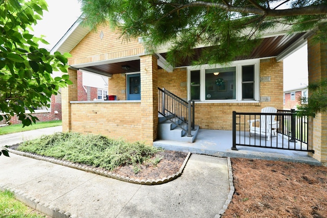 1336 N Butler Ave, Indianapolis, IN 46219 - view of front of home with brick siding and covered porch