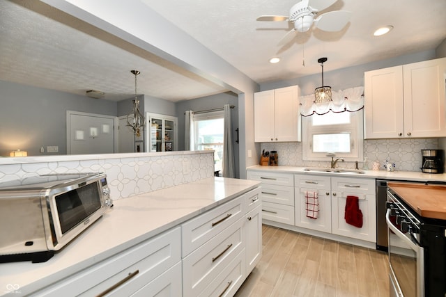 1336 N Butler Ave, Indianapolis, IN 46219 - kitchen featuring range, backsplash, a ceiling fan, white cabinets, and recessed lighting