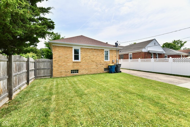 1336 N Butler Ave, Indianapolis, IN 46219 - rear view of house featuring brick siding, a fenced backyard, and crawl space