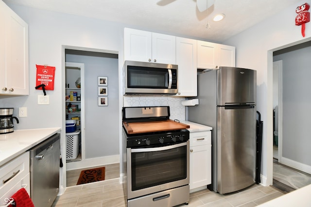 1336 N Butler Ave, Indianapolis, IN 46219 - kitchen featuring appliances with stainless steel finishes, tasteful backsplash, and white cabinetry