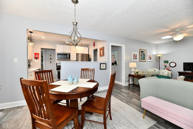 1336 N Butler Ave, Indianapolis, IN 46219 - dining area with a chandelier, wood finished floors, and ceiling fan