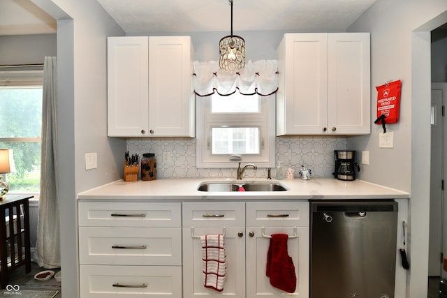 1336 N Butler Ave, Indianapolis, IN 46219 - kitchen featuring dishwasher, decorative backsplash, a chandelier, and white cabinetry