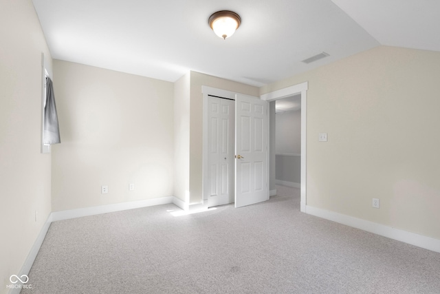 4224 River Rd, Columbus, IN 47203 - unfurnished bedroom featuring carpet, vaulted ceiling, and a closet