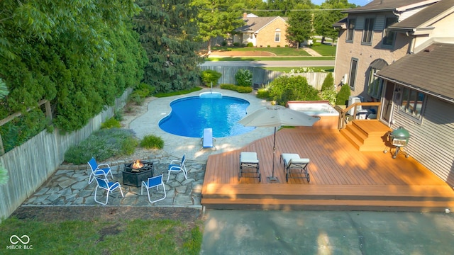 4224 River Rd, Columbus, IN 47203 - view of swimming pool featuring an outdoor fire pit, a deck, a fenced backyard, and a patio area