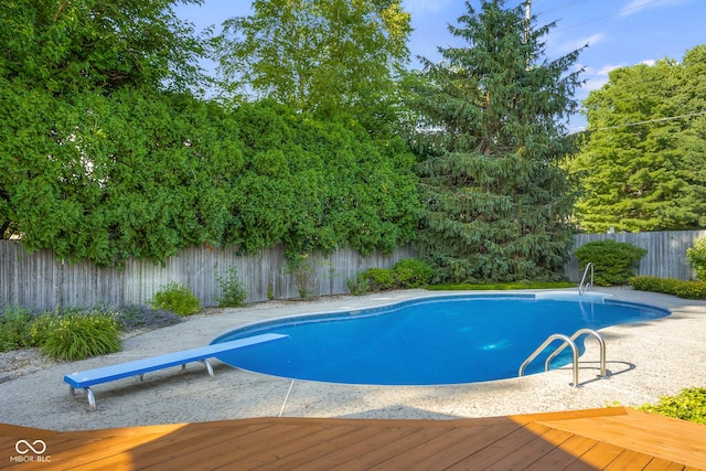 4224 River Rd, Columbus, IN 47203 - view of swimming pool featuring a fenced backyard, a wooden deck, and a diving board