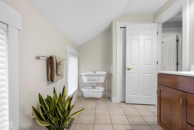 4224 River Rd, Columbus, IN 47203 - bathroom with vaulted ceiling, vanity, and tile patterned flooring