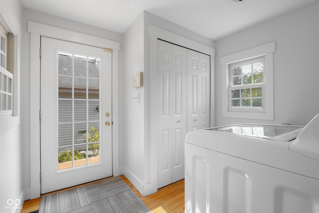 4224 River Rd, Columbus, IN 47203 - doorway to outside featuring washing machine and dryer and light wood-style flooring